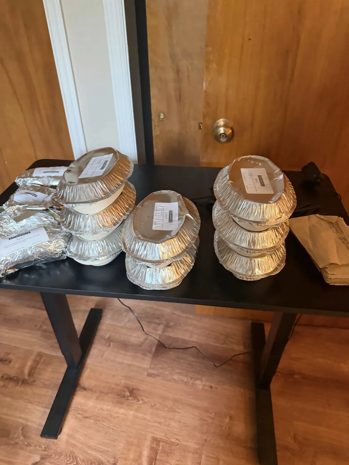 Stacked Chipotle catering trays on a table