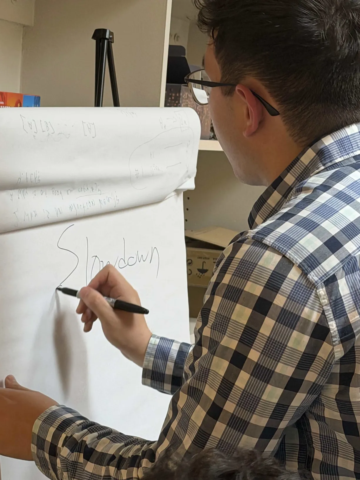 A presenter sketching notes on a flip chart